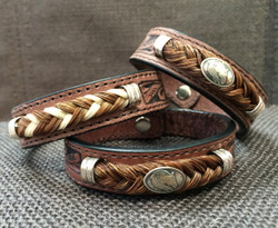 From Cowboy Collectibles these tooled leather bracelets feature classic western styling. Accented with sterling silver findings and braided horsehair, these bracelets are secured with a snap closure.

Bracelets come gift boxed and are available in Small - 7 1/8” Medium - 8”

Cowboy Collectible products are handmade in Montana, USA.