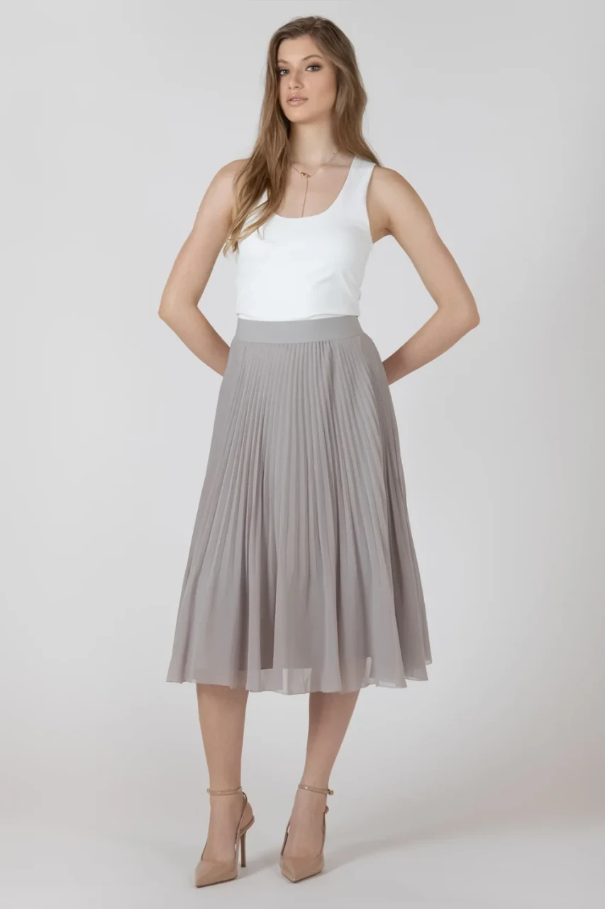Full-length portrait of model wearing Black Tape white scoopneck tank styled with denim