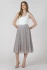Full-length portrait of model wearing Black Tape white scoopneck tank styled with denim