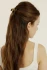 Full-length portrait of a woman with long brown hair styled half-up secured with the Kōv Essentials mini daily clip in blonde tortoise