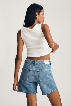 Back view of Mavi Heidi light brushed classic blue long shorts showing back pockets, waist fit, and clean back hem