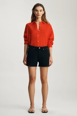 Full-length portrait of model wearing dark brushed feather luxe Mavi Heidi denim shorts styled casually
