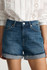 Close-up detail view of the mid brushed classic blue denim texture, folded cuff hem, and front pockets