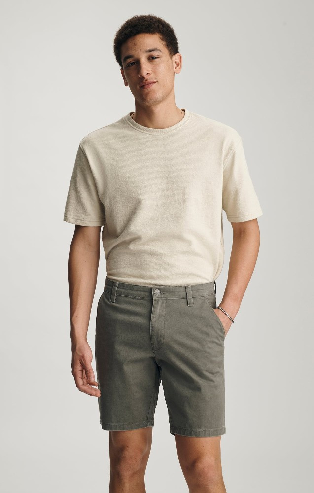 Front view of Mavi Noah mid rise 9 inch shorts in olive vintage colored showing waistband and trouser pockets