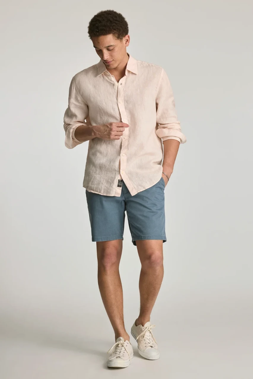 Front view of Mavi Noah mid rise 9 inch shorts in faded blue vintage colored showing waistband and trouser pockets