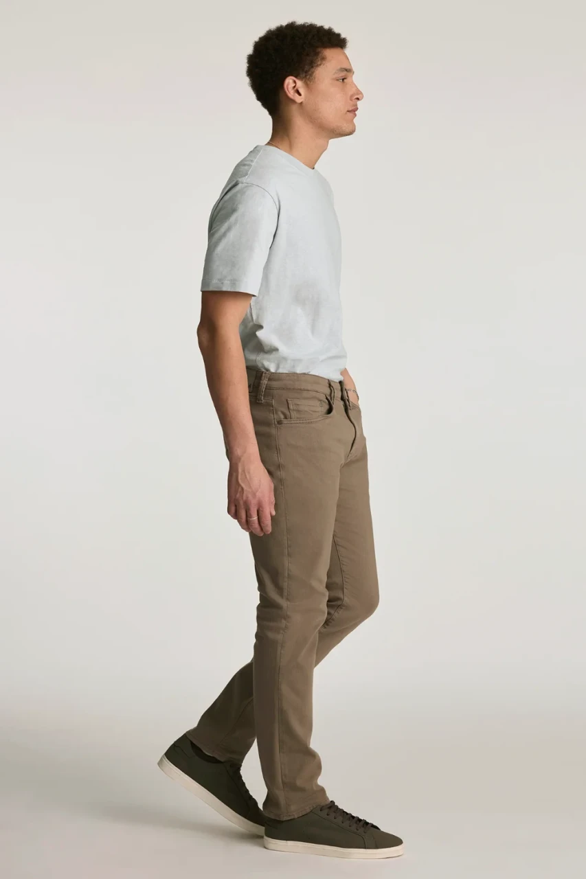 Side view of model wearing Mavi Marcus slim straight leg jeans highlighting the regular-rise waist and tailored leg fit