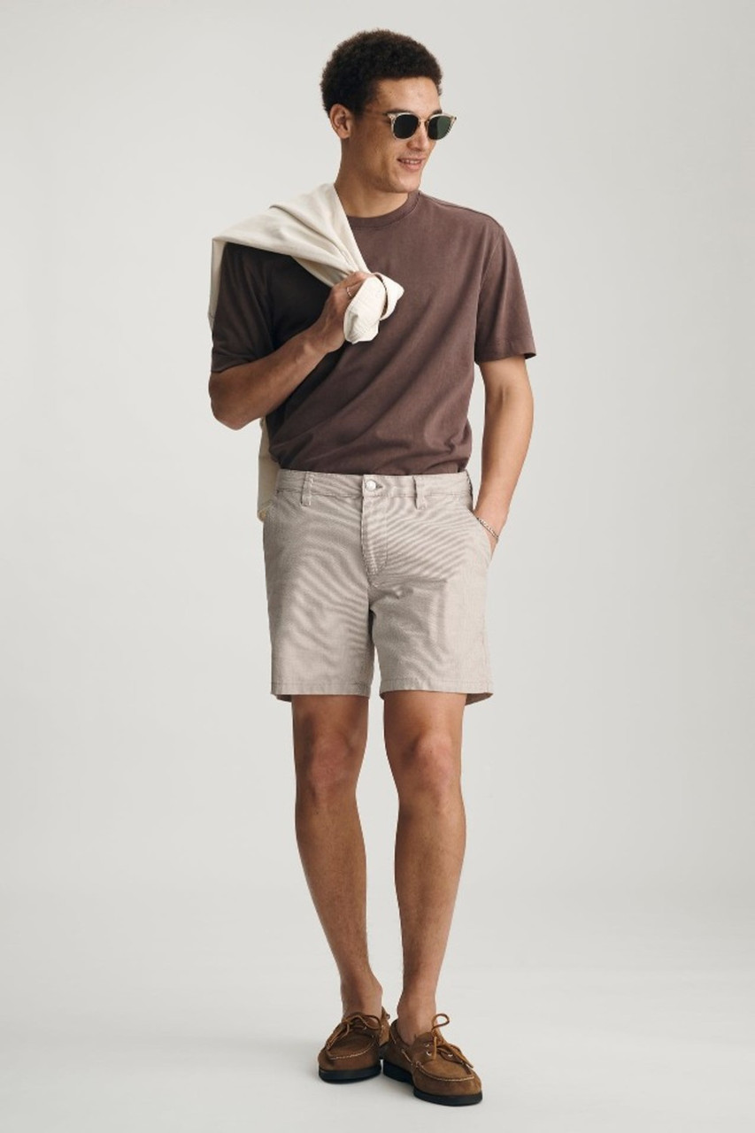 Full-length portrait of model wearing sand seersucker Mavi Nate tailored shorts styled casually