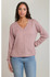 Front view of model wearing Dex V-neck knit sweater top in dusty rose with blue jeans