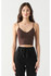 Front close-up view of model wearing Dex seamless cropped bra top in brown