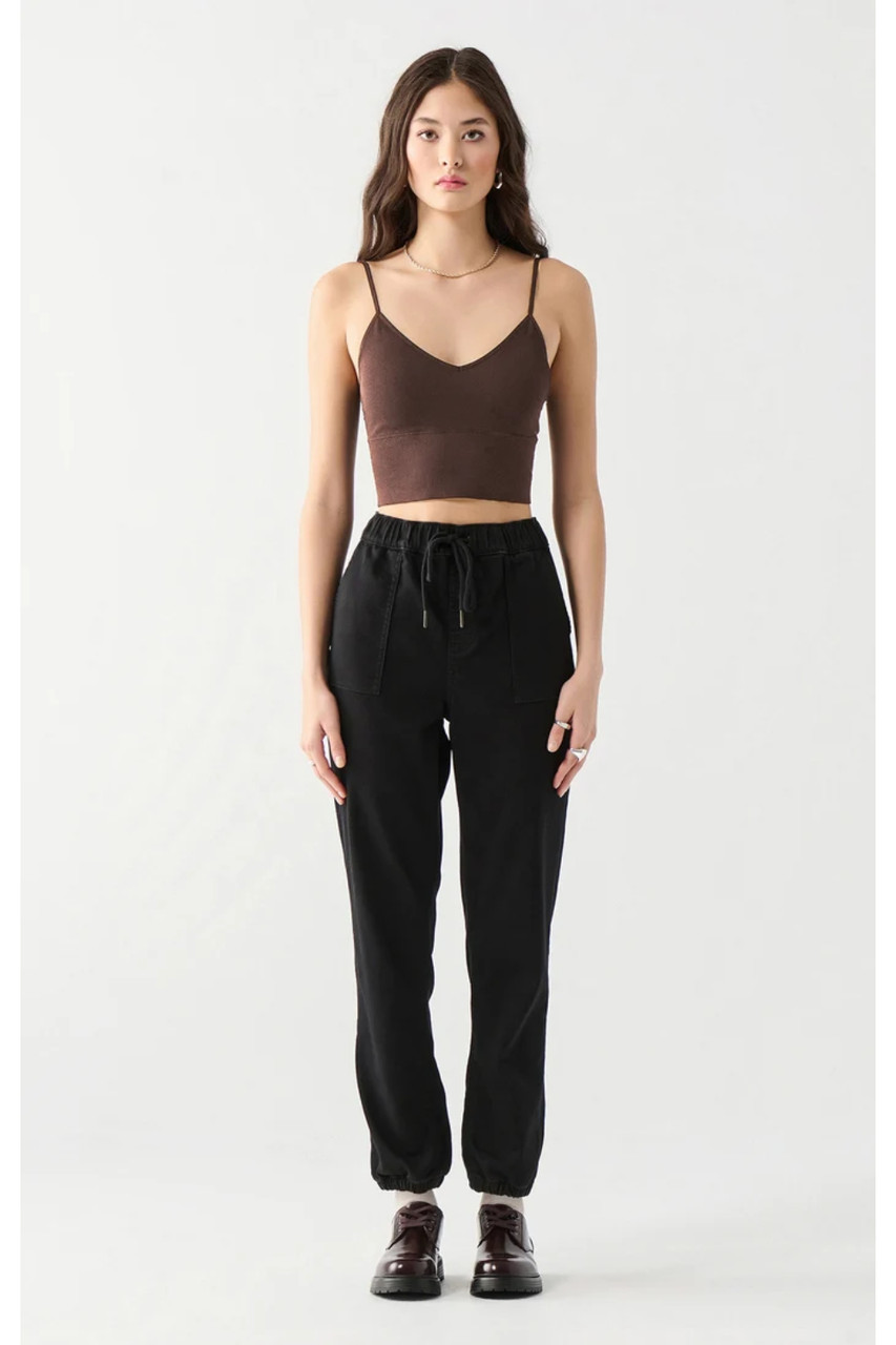 Front view of model wearing Dex seamless bra top in brown with black high-waisted pants