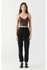 Front view of model wearing Dex seamless bra top in brown with black high-waisted pants