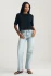 Full-length portrait of model wearing black Mavi Riley crew neck t-shirt styled with denim