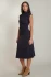 Full-length portrait of model wearing Black Tape navy Muse mockneck midi dress styled with boots