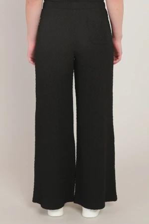 Front view of Room 34 textured wide-leg pants in black showing waistband and ribbed texture