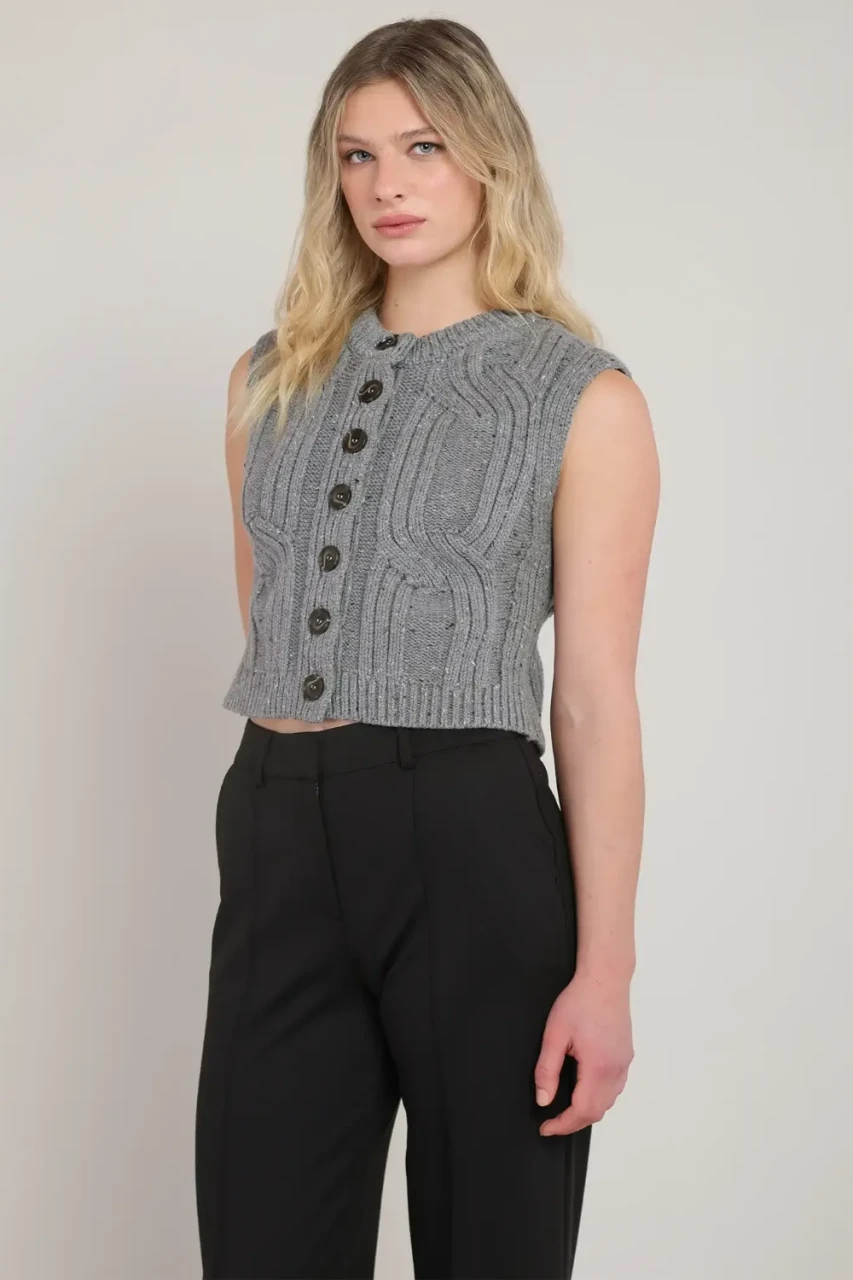 3/4 portrait of model wearing Room 34 grey button front cable knit sweater vest styled over top
