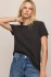 Posed front view of model wearing black sand Z Supply slub tee highlighting the relaxed drape and hem length