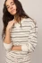 Close up view of model wearing cloud white Z Supply striped sweatshirt highlighting the relaxed fit and soft modal fleece texture