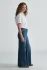 Side view of model wearing Mavi Florida wide leg jeans highlighting the high rise waist and wide leg opening