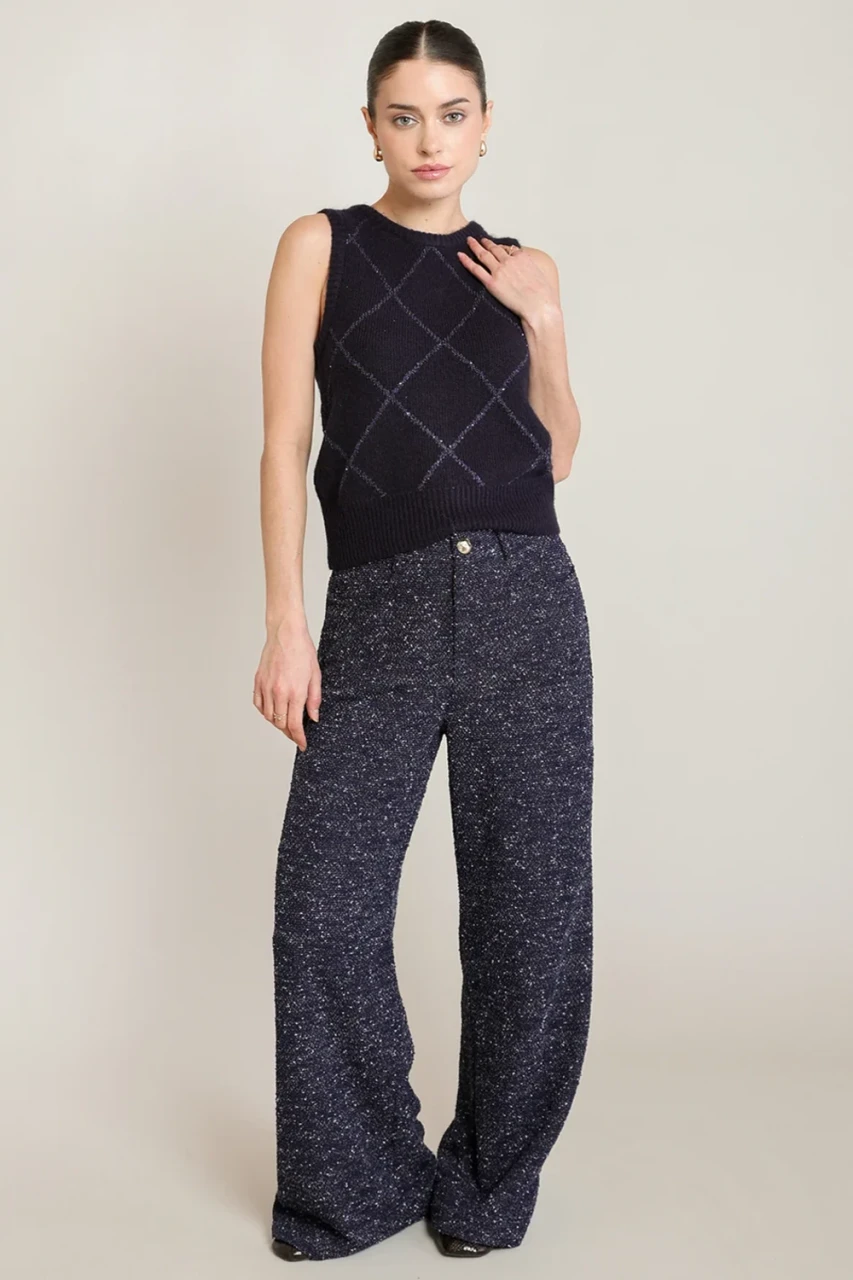 Full-length portrait of model wearing Black Tape navy blue melange boucle pants styled with knit top