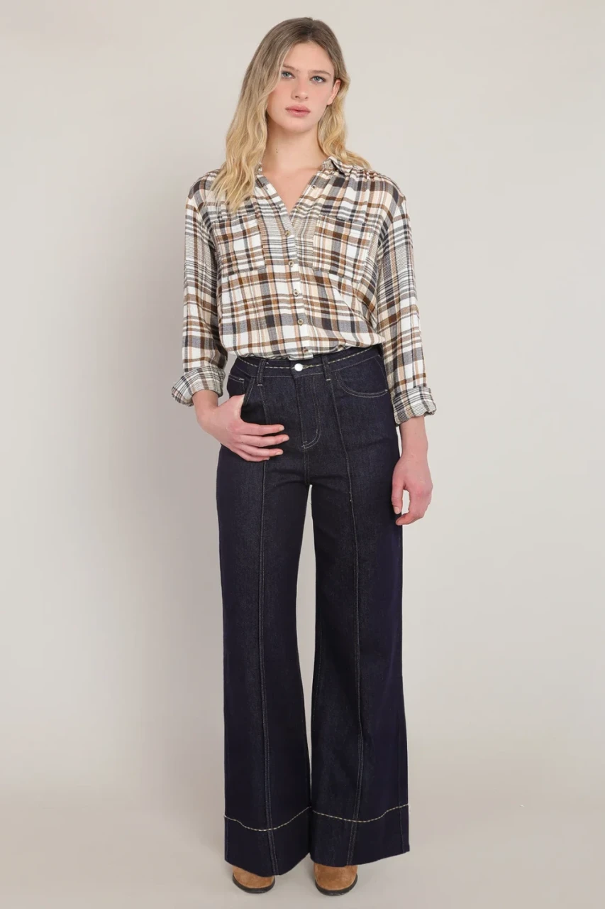 Full-length portrait of model wearing Room 34 brown navy Parker plaid button up shirt with denim