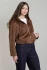 3/4 portrait of model wearing Dex brown faux suede hooded bomber jacket styled with dark denim