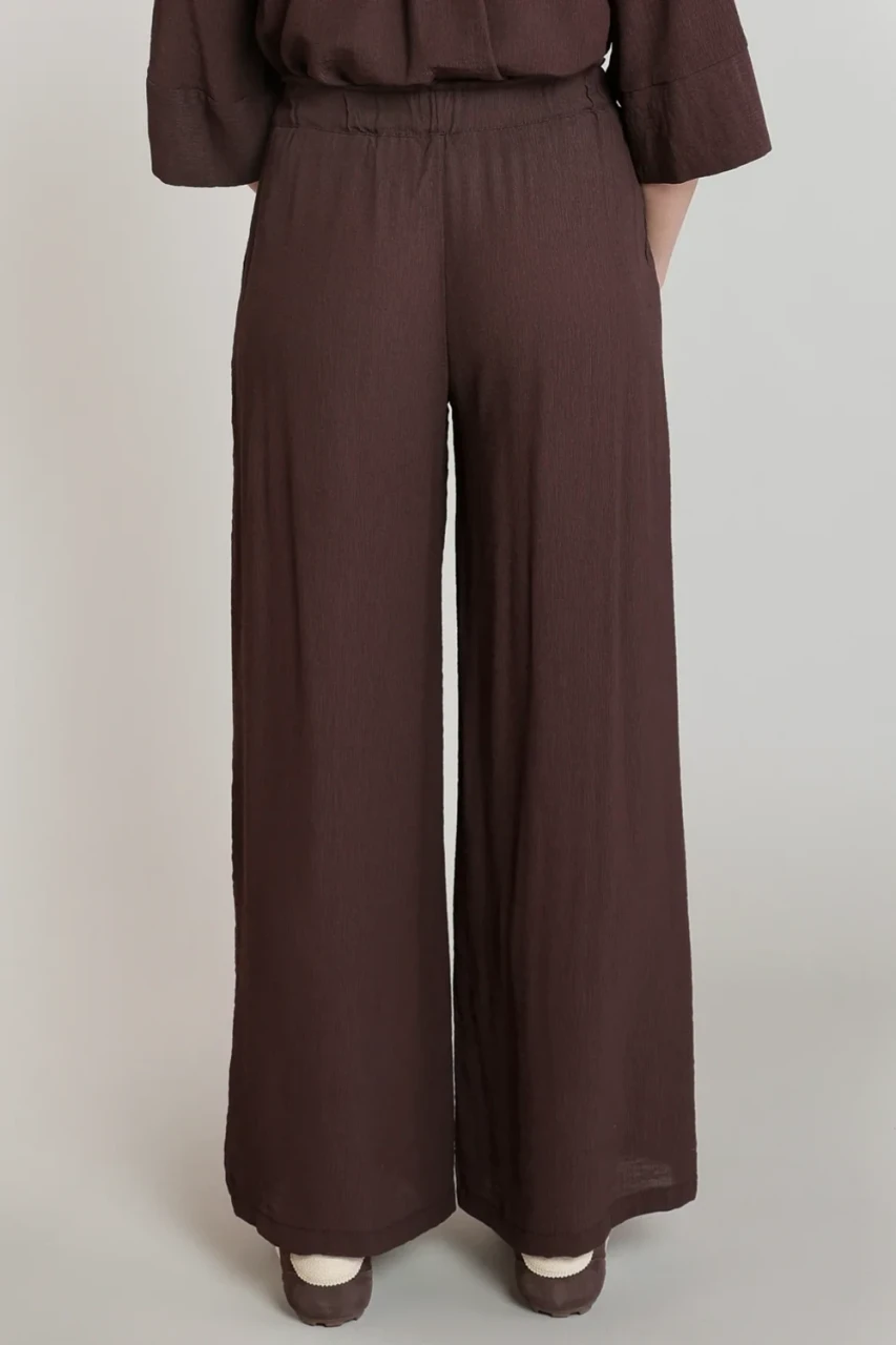 Back view of Dex dark chocolate flowy wide-leg pants showing clean high-waisted back detail