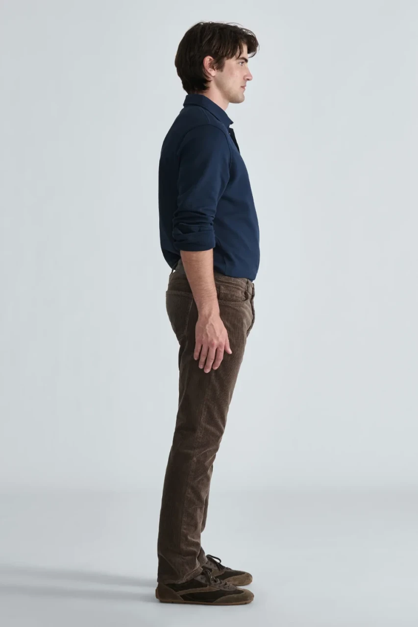 Side view of model wearing Mavi Marcus acorn corduroy pants highlighting the slim straight leg fit