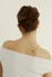 Back view closeup of an updo styled with the caramel-colored Kōv Essentials French pin in honey