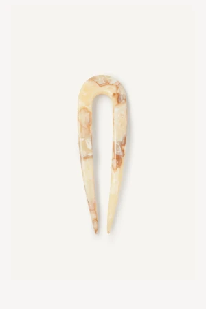 Close-up detail view of the warm cream-oak cellulose acetate texture and polished finish