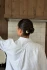 Back view of a person with an updo secured by a cream-colored Kōv Essentials French pin in oak