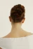 Back view closeup of a person with their hair in an updo secured by a tortoiseshell Kōv Essentials French pin