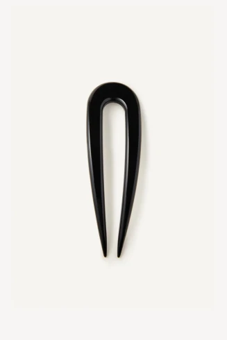 Close-up detail view of the glossy solid black cellulose acetate texture and polished finish