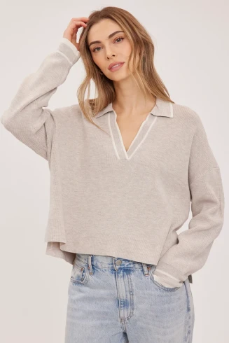Front view of Gentle Fawn Tristan sweater in heather latte showing collared v-neckline and contrast stripes