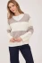 Full-length portrait of model wearing latte stripe Gentle Fawn Annalise sweater styled with denim