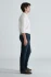 Side view of model wearing Mavi Marcus deep indigo jeans highlighting the slim straight leg fit and clean hem