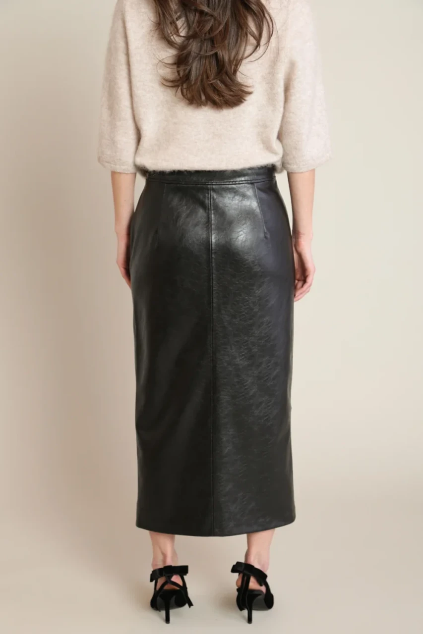 Back view of Black Tape black faux leather skirt showing clean seam lines and zip closure