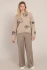 Full-length portrait of model wearing Room 34 taupe Francesca flower crewneck sweater styled with denim