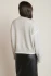 Back view of Black Tape light gray melange stitch turtleneck sweater showing clean drape and knit texture