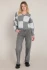 Full-length portrait of model wearing Dex heather grey block colorblock sweater styled with denim