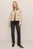 Full-length portrait of model wearing soapstone neutral Z Supply cropped denim chore jacket styled with high-waisted jeans