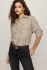 Model wearing dark chocolate brown Z Supply River plaid flannel shirt styled unbuttoned over a top