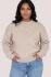 Front view of Gentle Fawn Tova sweater in heather pebble showing oversized crew neckline and heathered knit with hands in pocket
