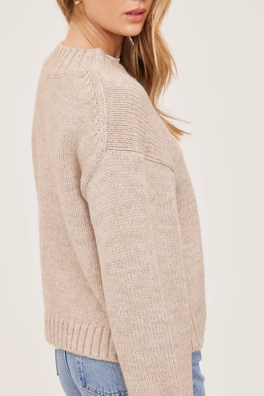 Over the shoulder profile view of model wearing heather pebble grey Gentle Fawn Tova sweater showing the relaxed fit and cropped hem