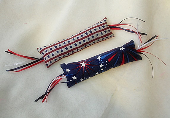 Fun catnip filled fire cracker with patriotic fabric, and  a burst of ribbon.