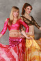 two women wearing akhet holographic lycra mock wrap top in pink and copper color