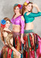 three women posing, wearing akhet holographic lycra mock wrap top featuring golden, pink, and green colors