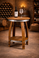 Rustic wine barrel side table made from reclaimed oak wine barrels with round barrel head top and lower shelf