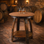 Rustic whiskey barrel side table made from reclaimed oak whiskey barrels with lower shelf