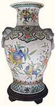 Exotic Chinese porcelain radish vase. Meticulously hand painted in traditional pomegranate floral design. Asian arabesque borders & emperor lion handles. Choose fine Chinese porcelain to enhance your living room. Unlike ceramics, its stronger & less brittle. Display it with a 6��?�� round rosewood vase stand for optimal visual appeal. Or we can make it a lamp. More fine Chinese porcelain values on our website. Get yours now. Rare imported treasures like this sell quickly. 9��?��x14��?��H