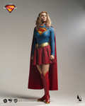 Dynamic action pose of the Supergirl collectible figure hovering above her custom environmental display base.
